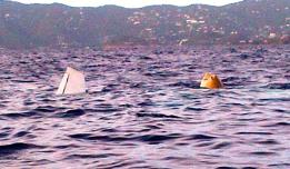 A wing of the recovered plane breaks the surface. The plane was floated using air bags. (Government House photo) A wing of the recovered plane breaks the surface. The plane was floated using air bags. (Government House photo)